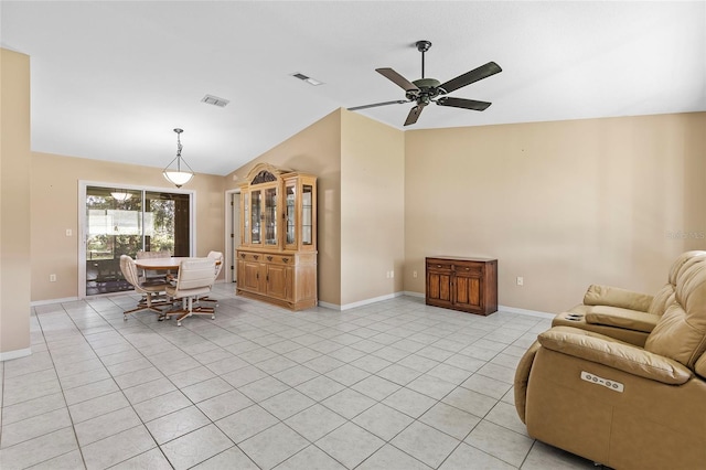 living room with lofted ceiling, visible vents, and light tile patterned flooring