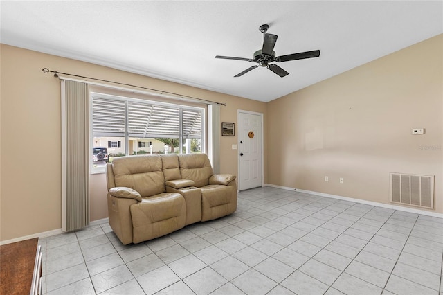 living area with light tile patterned floors, baseboards, visible vents, and a ceiling fan