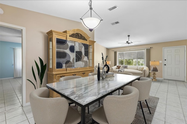 dining area featuring light tile patterned floors, baseboards, visible vents, and a ceiling fan