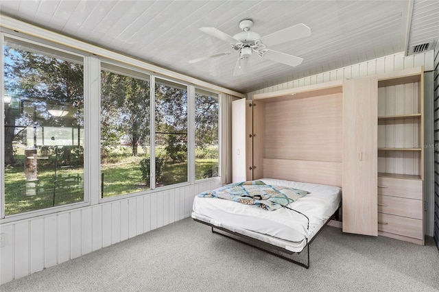 bedroom with ceiling fan, wooden ceiling, and carpet flooring