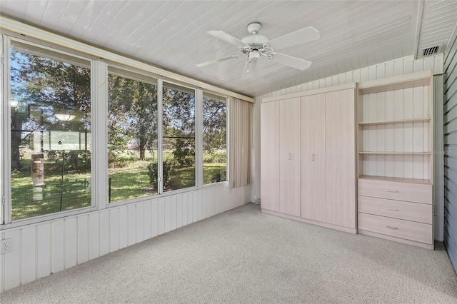 unfurnished sunroom featuring visible vents, wood ceiling, and a ceiling fan