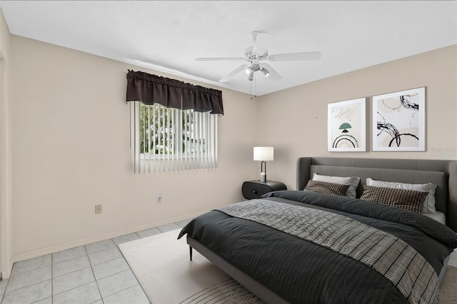 bedroom with light tile patterned floors, baseboards, and a ceiling fan