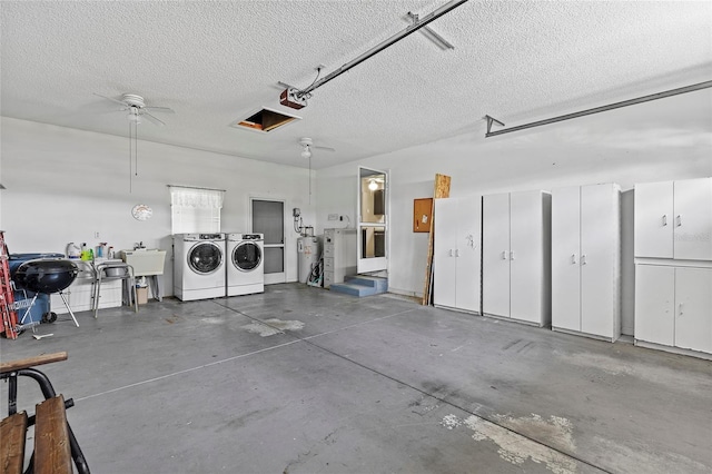 garage featuring washing machine and dryer, a sink, and a garage door opener