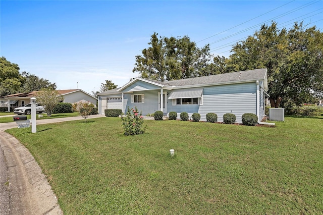 ranch-style house featuring an attached garage, driveway, central AC unit, and a front yard