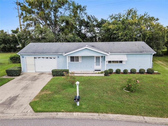 ranch-style house with a garage, a front yard, and driveway