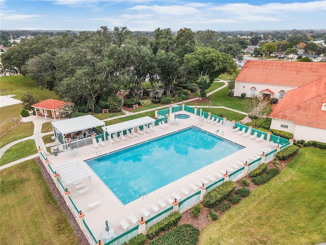 pool with fence, a lawn, and a patio