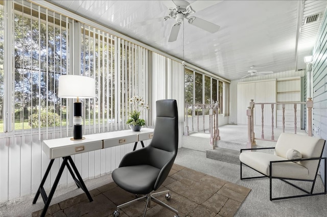 sunroom / solarium with a healthy amount of sunlight and a ceiling fan