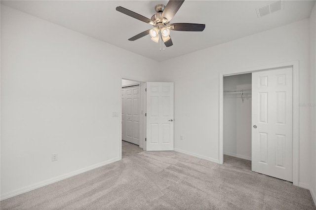 unfurnished bedroom featuring ceiling fan, a closet, and light colored carpet