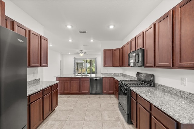 kitchen with black appliances, sink, ceiling fan, light stone counters, and kitchen peninsula