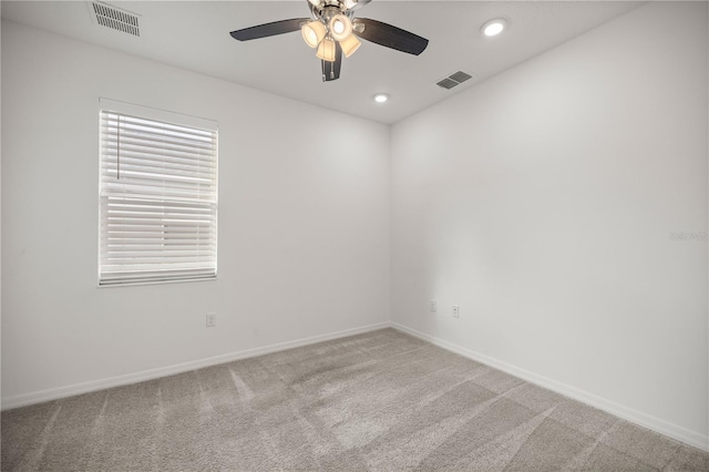 spare room featuring ceiling fan and light colored carpet