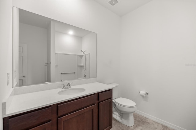 bathroom featuring walk in shower, tile patterned flooring, vanity, and toilet