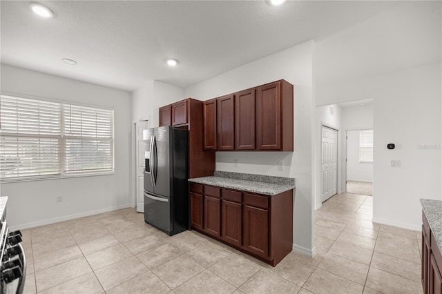 kitchen with appliances with stainless steel finishes and light tile patterned flooring