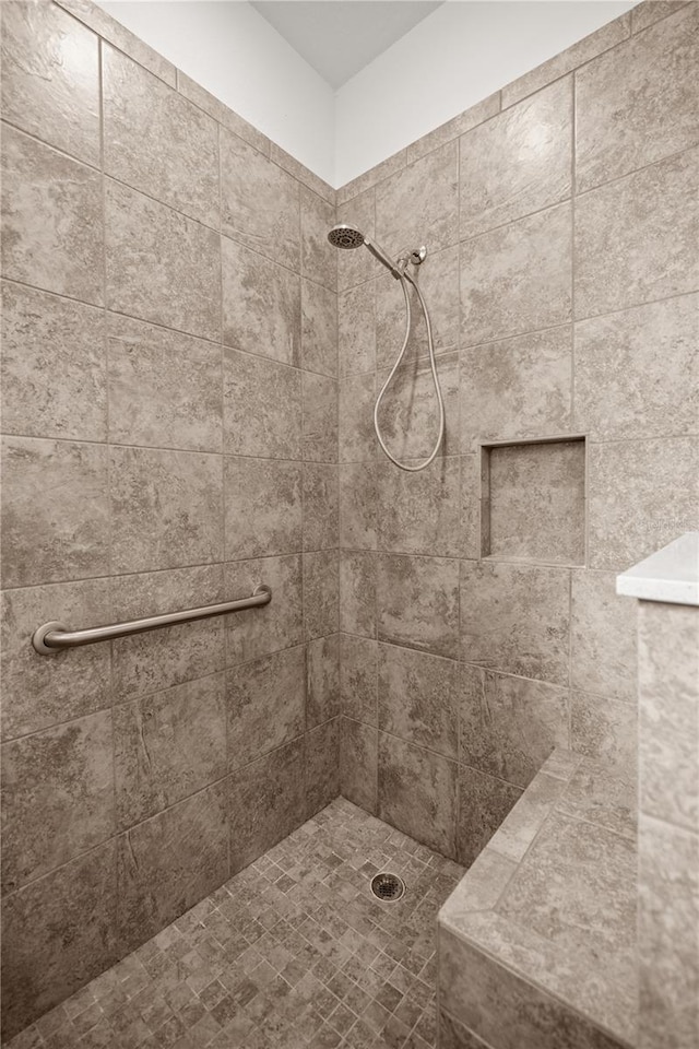 bathroom with a tile shower