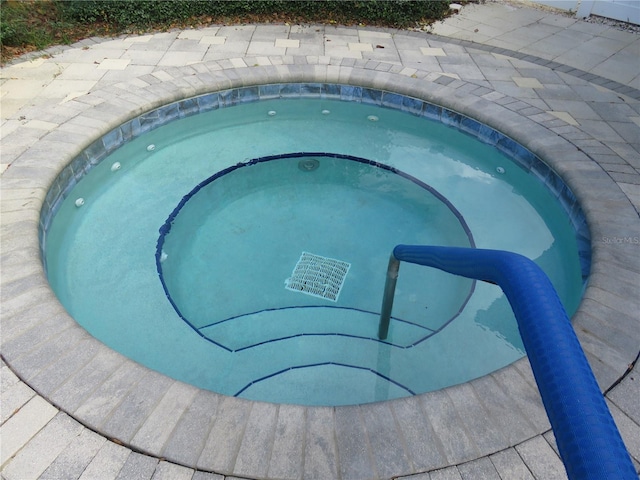 view of swimming pool featuring an in ground hot tub