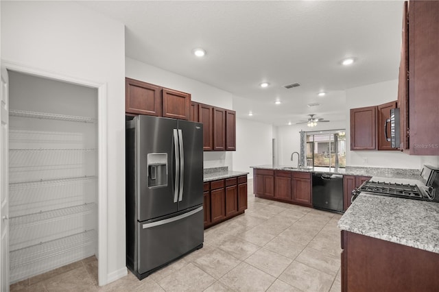 kitchen featuring stove, sink, ceiling fan, stainless steel fridge, and black dishwasher