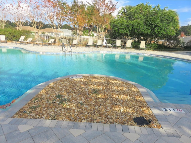 view of swimming pool with a patio area