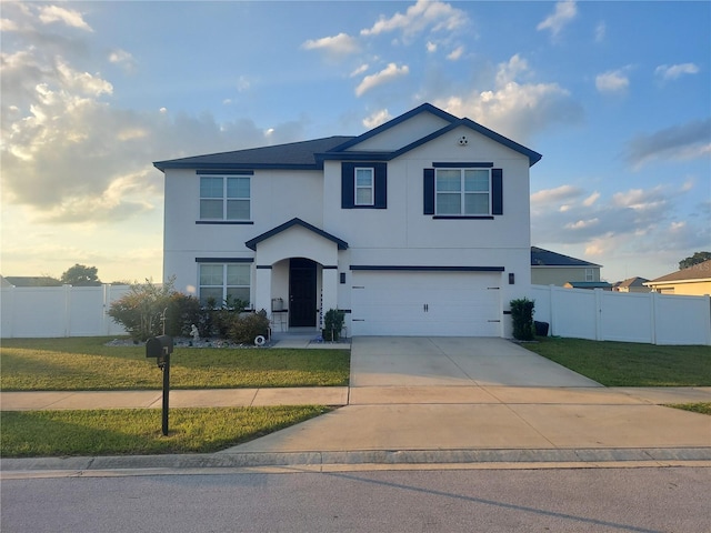 view of property featuring a front yard and a garage