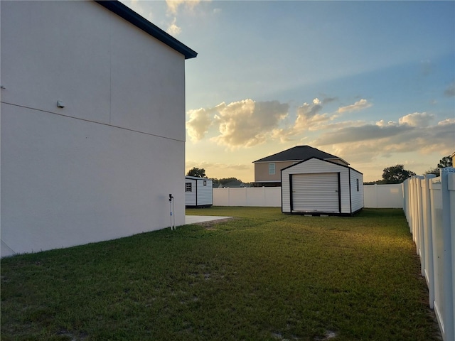 yard at dusk featuring a shed