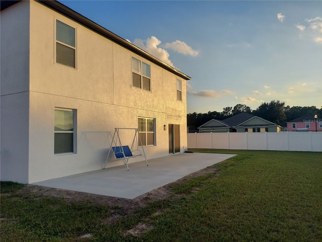 rear view of property with a patio and a yard