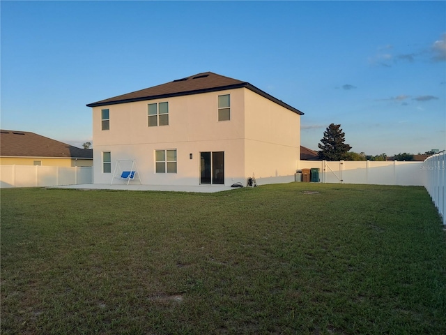 rear view of house with a yard