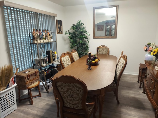 dining area featuring wood-type flooring and a healthy amount of sunlight