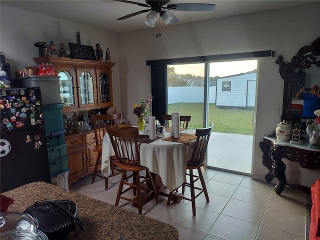 dining room featuring ceiling fan and light tile patterned floors