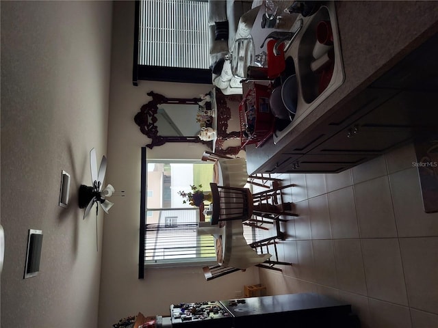 dining area featuring tile walls