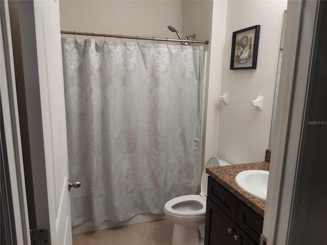 bathroom with vanity, tile patterned flooring, toilet, and curtained shower