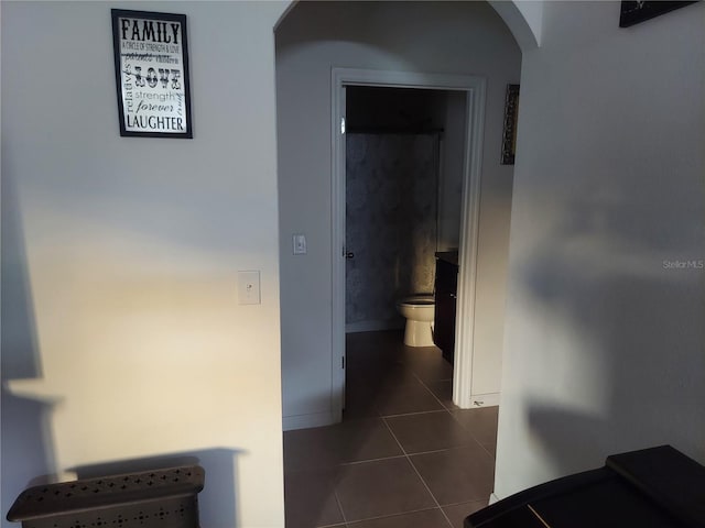 corridor featuring dark tile patterned flooring