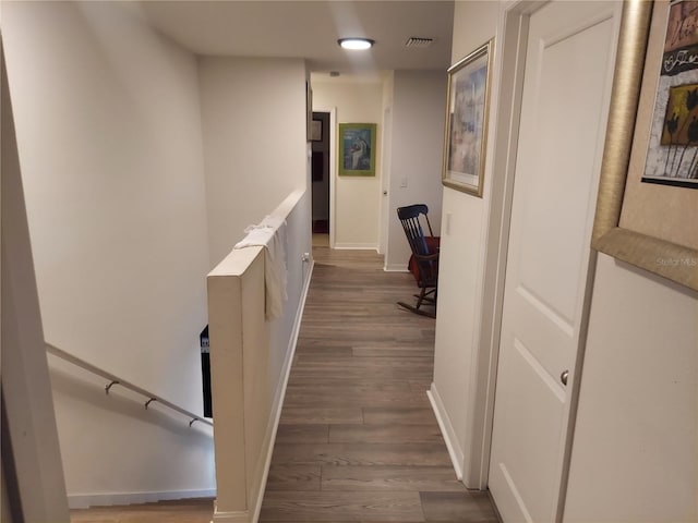 hallway with dark hardwood / wood-style flooring