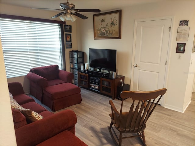 living room with light wood-type flooring and ceiling fan