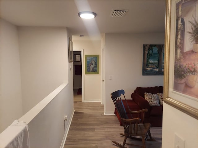 hallway with hardwood / wood-style flooring