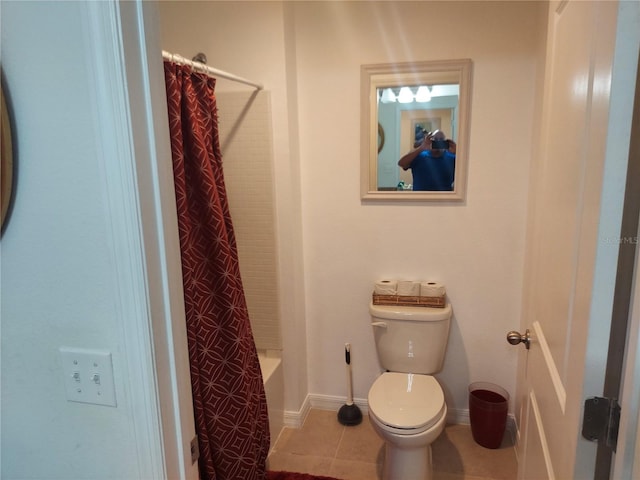 bathroom featuring shower / bathtub combination with curtain, toilet, and tile patterned floors