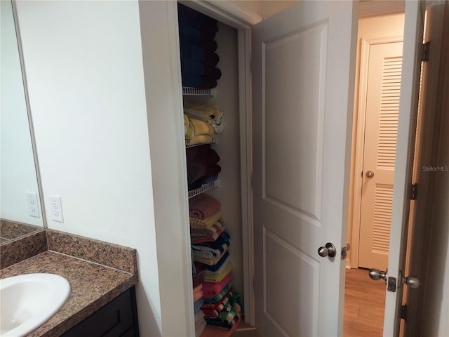 bathroom with vanity and hardwood / wood-style floors