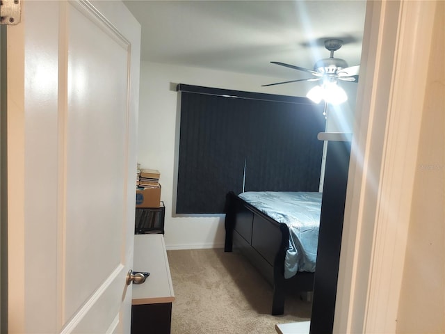 bedroom with ceiling fan and light colored carpet