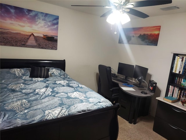 bedroom with ceiling fan and light carpet