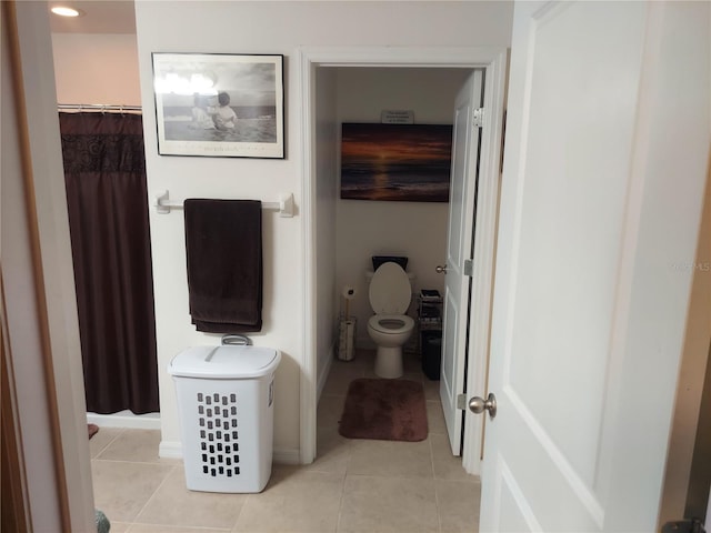 bathroom featuring tile patterned flooring and toilet