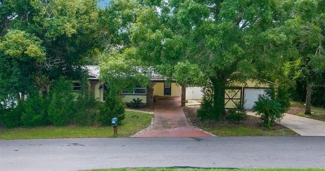 obstructed view of property featuring a garage