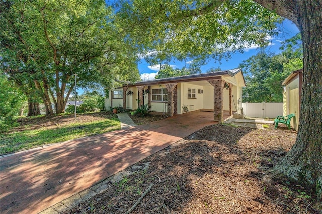 single story home featuring fence