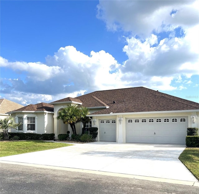 view of front of house featuring a garage and a front lawn