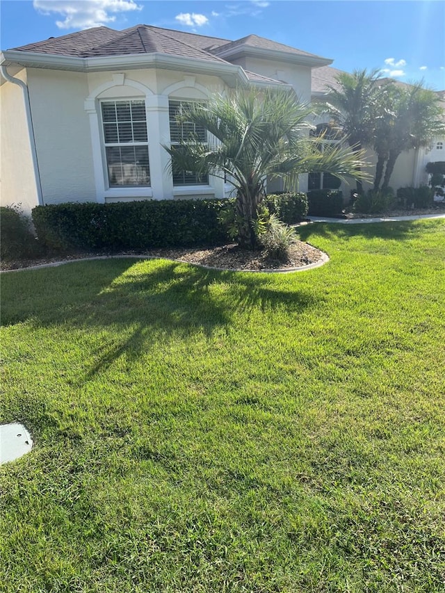 view of property exterior with a lawn