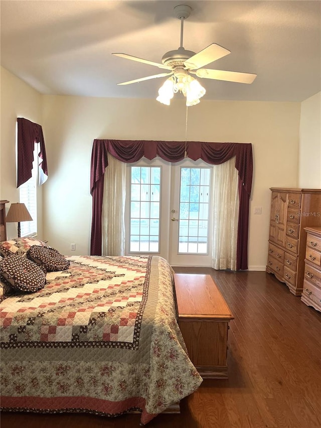 bedroom with dark hardwood / wood-style flooring and ceiling fan