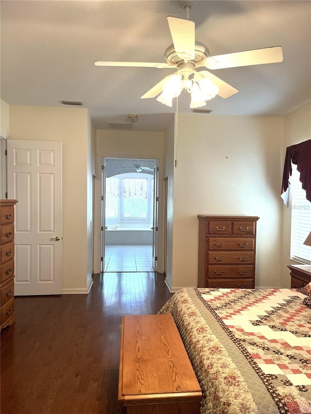 bedroom featuring multiple windows, dark hardwood / wood-style flooring, and ceiling fan