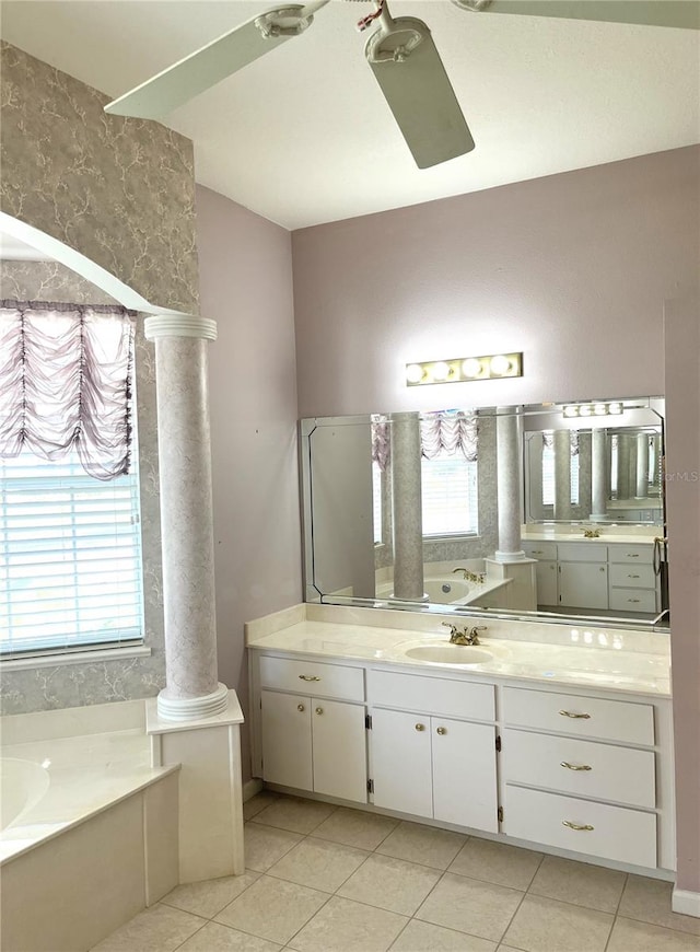 bathroom with ceiling fan, vanity, a bathtub, tile patterned floors, and ornate columns