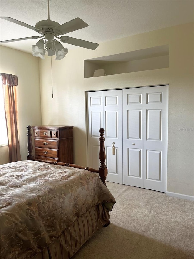 bedroom with light carpet, a closet, and ceiling fan