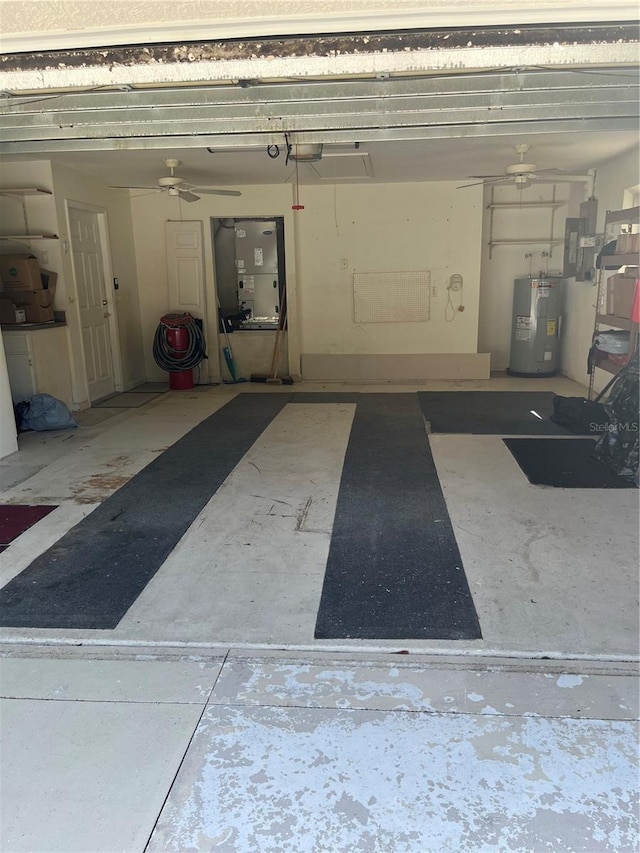 garage featuring water heater, ceiling fan, and a garage door opener