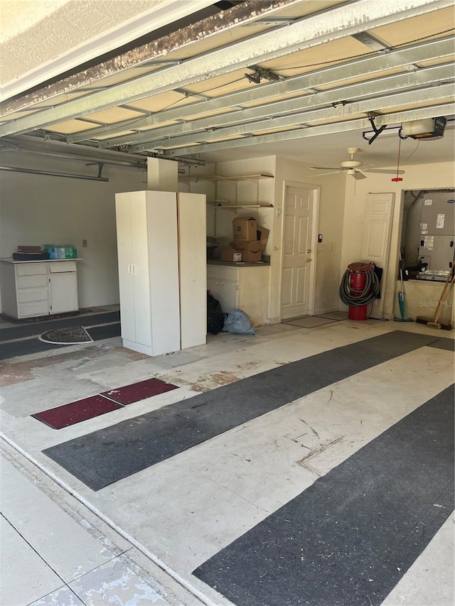 garage with a garage door opener and ceiling fan