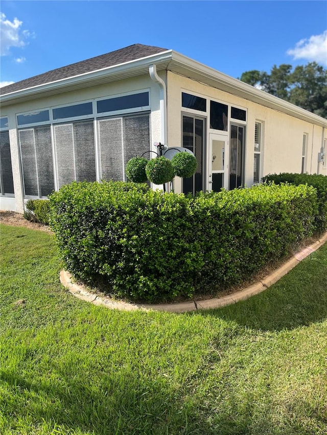 view of home's exterior with a lawn