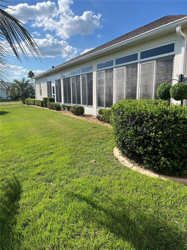 exterior space featuring a sunroom and a yard