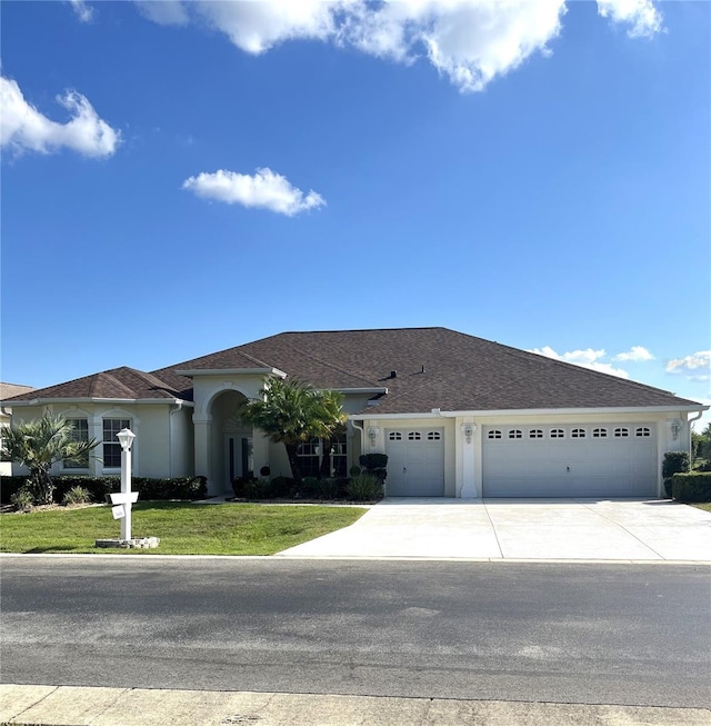 view of front of home featuring a garage and a front lawn